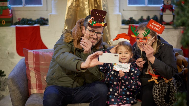 Family in Santa's grotto taking a selfie
